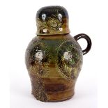 A pottery slipware cider jug and cover, modelled as an owl, by Leonard Stockley of Weymouth pottery,