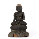 A Thai ebonised carved wood figure of a Buddha seated cross-legged on a throne, 63.