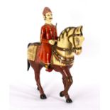 An Indian painted and decorated horse and rider, the rider in ceremonial dress,