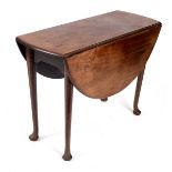 A mahogany oval two-flap table, on turned tapered legs with pad feet,