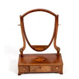 A 19th Century mahogany toilet mirror of shield shape on a shell patera inlaid three-drawer base,