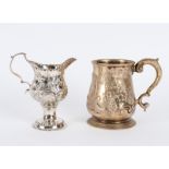 A George III silver embossed jug, London 1771, 11cm high and a George III silver mug,