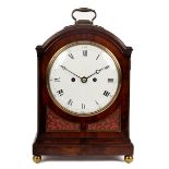 A Regency mahogany bracket clock circa 1800, the arched and moulded case with brass banding,