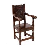 A child's 17th Century style oak chair with carved back and seat on baluster legs