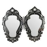 A pair of Venetian style wall mirrors, the cartouche shaped plates with segmented mirror surround,