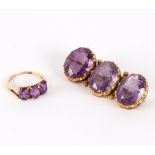 An amethyst three-stone brooch,