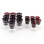 A part suite of clear-flash ruby glasses comprising ten large and seven smaller goblets,