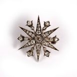 A diamond starburst brooch/pendant, the pin removable, 3cm wide, approximately 6.