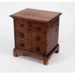 A small oak cupboard enclosed by panel doors each disguised as three drawers, fitted interior, 45.