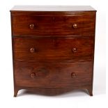 A Victorian mahogany bowfront chest of three drawers, on splay feet,