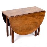 A George III mahogany oval two-flap table on square chamfered legs,