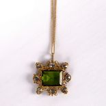 A tourmaline pendant with border of eight rose cut diamonds to a fine 9ct gold neck chain,
