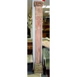 A pair of Chinese temple columns with carved capitals, reeded columns and carved stone bases,