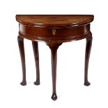 A George II walnut half-round tea table, on plain cabriole legs with pointed toes,
