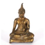 A small gilded figure of a Buddha seated cross-legged,