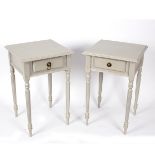 A pair of painted bedside tables, each fitted a drawer,