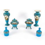 A Sèvres style garniture of four turquoise ground vases painted with reserves of birds,