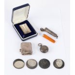 An amber and gold mounted cheroot holder in silver outer case, a silver sovereign holder,
