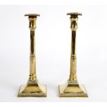 A pair of brass candlesticks, circa 1790,