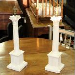 A pair of pottery table lamp bases of Corinthian column form, the fluted columns on square plinths,