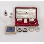 A silver three-piece cruet set, Birmingham 1980, comprising salt, pepper,