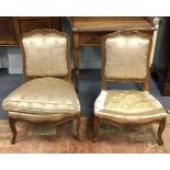 A pair of French beech framed nursing chairs