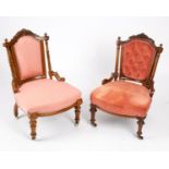 A near pair of Edwardian walnut framed nursing chairs with carved crest rails above upholstered