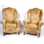 A pair of wing back armchairs,