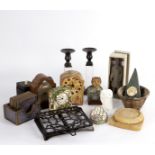A small group of decorative objects including candlesticks,