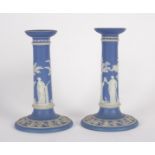 A pair of Wedgwood blue jasper candlesticks, sprigged with Classical figures,