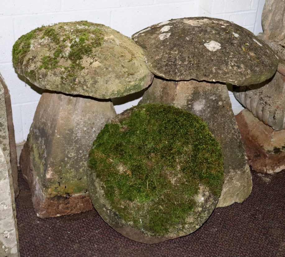 Two staddle stones with bases and a spare tops