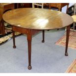A George III mahogany two-flap table on round legs with pad feet,