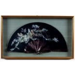 A fan with tortoiseshell sticks embroidered flowers, in a glazed case,