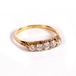 A diamond five-stone ring in a scroll setting to an 18ct yellow gold shank,