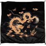 A Chinese silk embroidered panel depicting a coiling dragon chasing a flaming pearl,