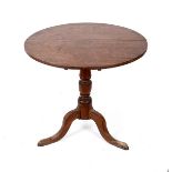 An early 19th Century circular table on a turned column and tripod support,
