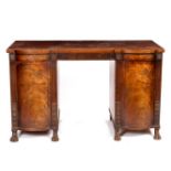 A Regency mahogany sideboard with reeded frieze and bowfront pedestals on carved paw feet,