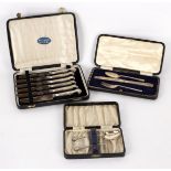 Six silver handled fruit knives, cased, a Christening set initialled PED comprising knife,