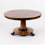 A William IV rosewood breakfast table on octagonal column and circular platform with carved scroll