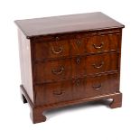 A mahogany chest of three drawers with brushing slide on bracket feet,
