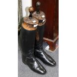 A pair of black leather riding boots with trees