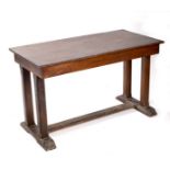An oak table on square chamfered end supports,