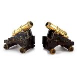 A pair of Militaire bronze cannons, circa 1820, on wooden wheeled carriages,