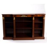 A Regency style breakfront bookcase in the Egyptian revival manner,