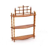 A set of serpentine front wall hanging shelves, the three shelves united by faux bamboo uprights,