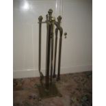 An early 20th century brass 4 piece companion set, 75cm high.