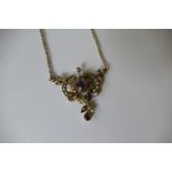 A 9ct gold seed pearl and amethyst pendent on an associated 9ct gold chain (5.4g all in).