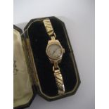 A ladies 9 ct gold watch in fitted case, associated strap, the back wath plate stamped 375.