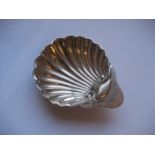 A silver shell scallop soap dish raised on three ball feet, 1oz.