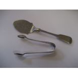 A pair of silver sugar tongs (0.4oz) and a plated spoon (2).